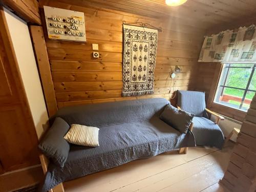 a living room with a couch and a window at Arola 2 in Syöte