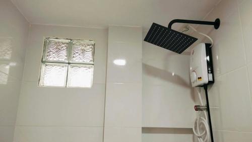 a bathroom with a shower and a window at TDGuestRoom Siargao in Dapa