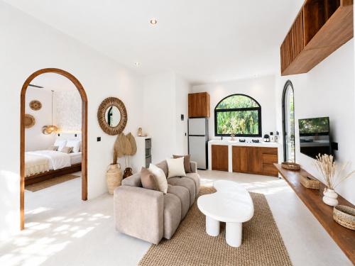 a living room with a couch and a table at Ôkeanos Boutique Hotel - Uluwatu Ungasan in Uluwatu