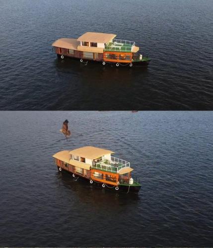 two boats in the water with a bird in the water at Navora Houseboats in Alleppey