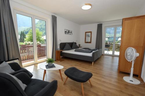 a living room with a couch and a table at Pension Bergfried in Hallstatt