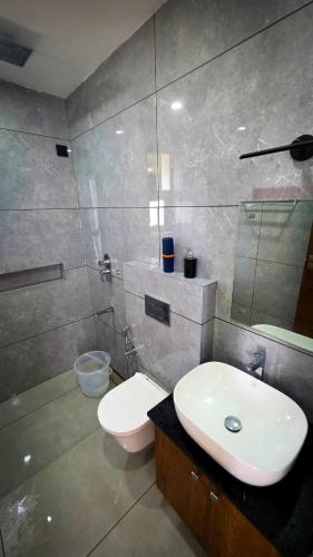 a bathroom with a white sink and a toilet at Indian Bungalows in Vagamon