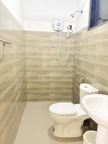 a bathroom with a toilet and a sink at The Wild Lotus YALA in Tissamaharama