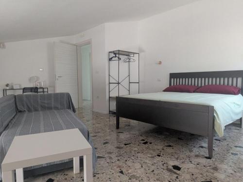 a bedroom with two beds and a table in it at Il quadrifoglio in Serino