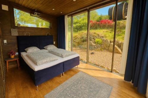a bedroom with a bed in front of a window at Animal trail in Sandnes