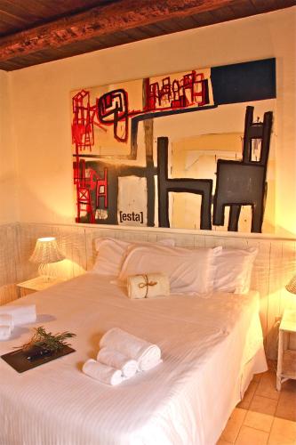 a bedroom with a white bed with towels on it at Riserva Privata San Settimio in Arcevia
