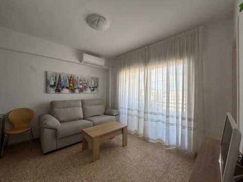 a living room with a couch and a window at NEW UDYNO in Piles