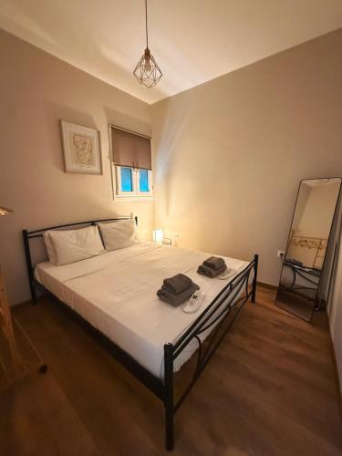 a bedroom with a large bed with white sheets at Dear_Jo_Guesthouse in Vathý