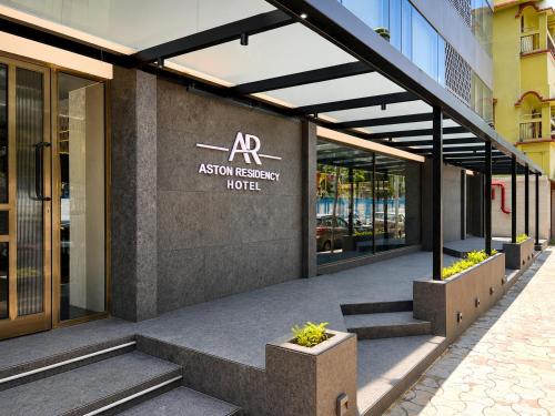 an asotin reception hotel building with stairs in front of it at Hotel Aston Residency in Kolkata