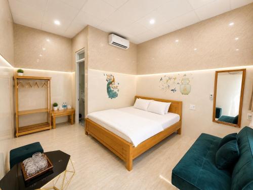 a bedroom with a bed and a couch at Garden House Nha Trang in Nha Trang