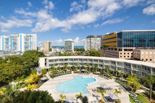 an aerial view of a building with a swimming pool at Hyatt Centric San Juan Isla Verde in San Juan