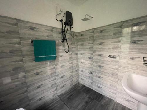 a bathroom with a shower and a sink and a tub at D&D Holyday Homes in Kandy
