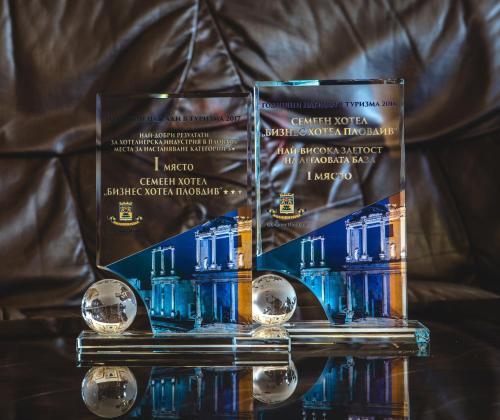 two awards sitting on top of a table at Business Hotel Plovdiv - Central Location in Plovdiv