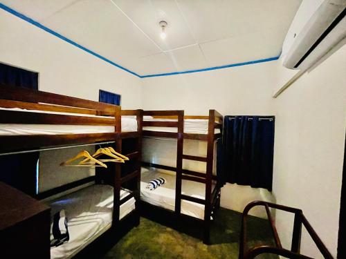a room with two bunk beds in a room at Lagoon Hostel in Arugam Bay