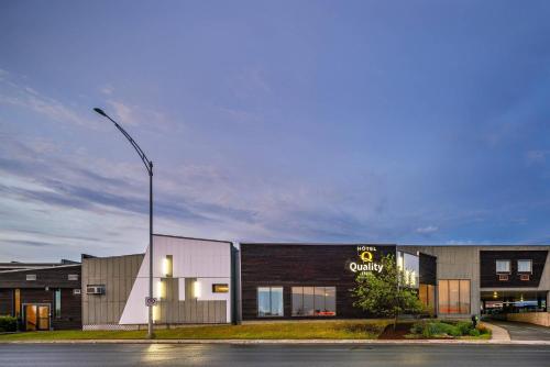 a building with a street light in front of it at Quality Inn Rouyn-Noranda in Rouyn-Noranda