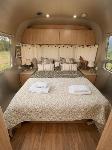 a large bed in the back of a camper van at Bieszczadzki Airstream in Wetlina