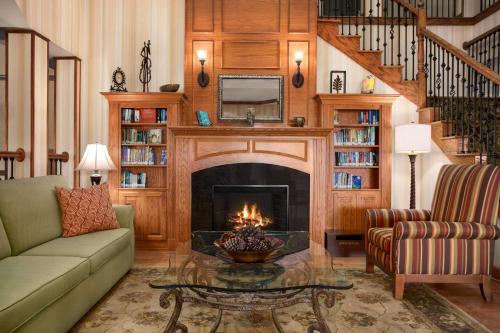 a living room with a fireplace and a couch at Country Inn & Suites by Radisson, Albany, GA in Albany