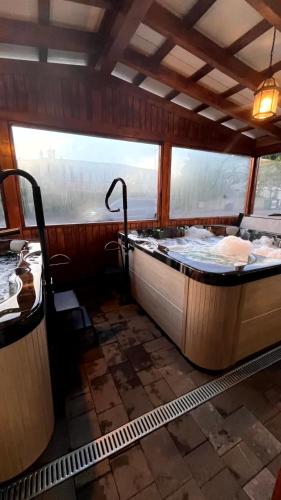 a large bath tub in a room with a window at Willa ROZA in Łeba