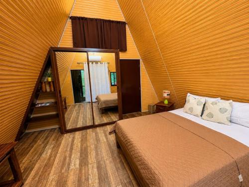 a bedroom with a bed and a large mirror at Villas alpinas in Concepción de La Vega