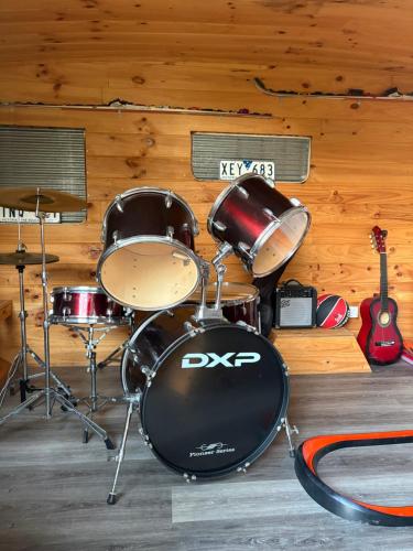 a drum set in a room with a wall at The Bloom Farm Cottage in Carrajung South