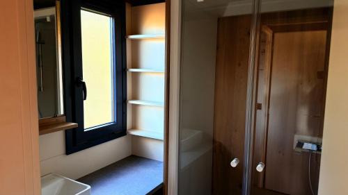 a bathroom with a window and a sink and a shower at Auberge Ferayola in Galeria