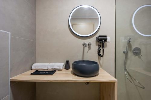 a bathroom with a sink and a mirror on a counter at Aurea Ionian Villas in Apolpaina