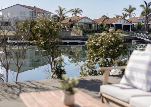a bench and a chair next to a body of water at Smada Stay - 4BR, Waterfront, Perfect Entertainer in Port Lincoln