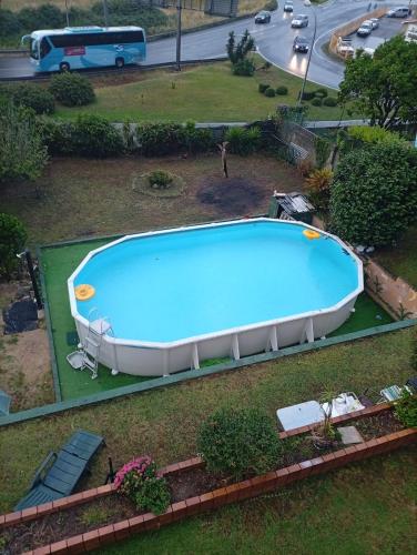 an overhead view of a swimming pool in a yard at Elena's bar loft in Poio