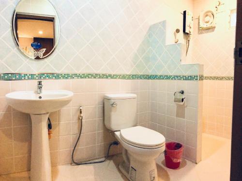 a bathroom with a toilet and a sink at เก็บตะวัน รีสอร์ท in Ban Hua Khao Sammuk