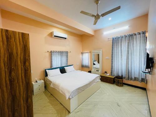 a bedroom with a bed and a television in it at Vedsa haveli new in Udaipur