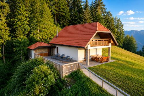 a small house with a deck and a roof at Mohoričeva domačija in Idrija