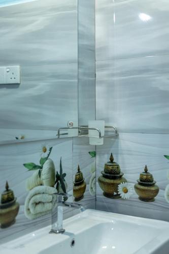 a mirror above a sink in a bathroom at Rainforest Soul Villa in Mederipitiya