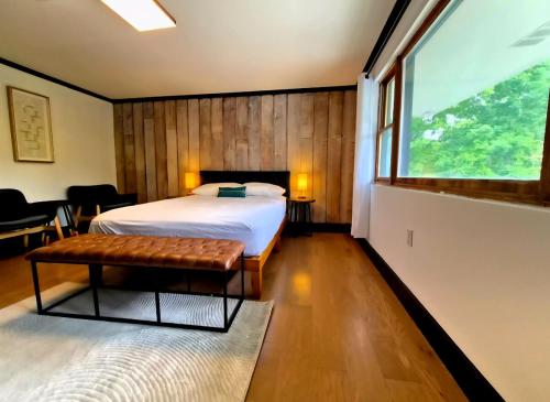 a bedroom with a bed and a large window at Lumen Catskill NY in Roscoe