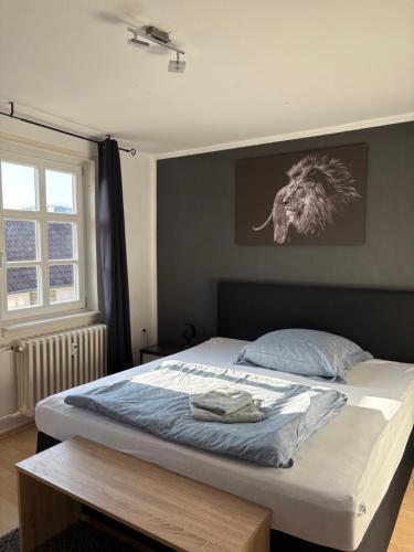 a bed in a bedroom with a picture of an elephant on the wall at Fluss-Bett in Melsungen