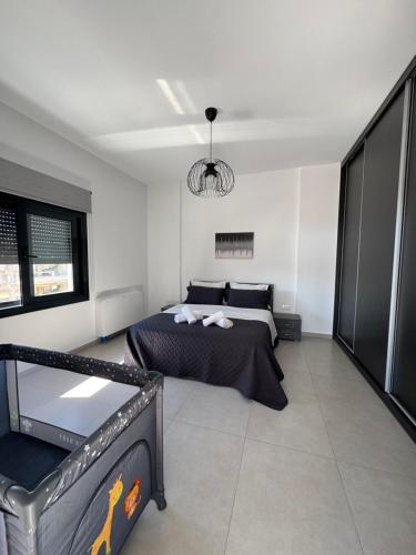 a bedroom with a bed in a white room at Meintis Apartments Rafina in Rafina