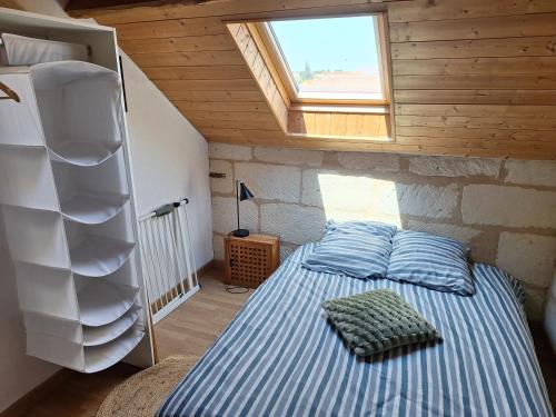 a small bedroom with a bed in a attic at Maison Cosy Saumur in Saumur