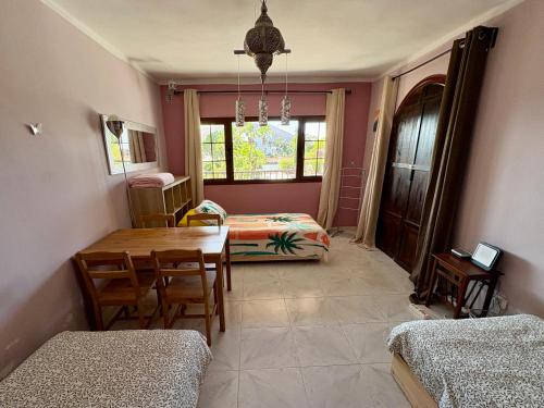a room with a dining table and a bedroom at myplace in Tiagua