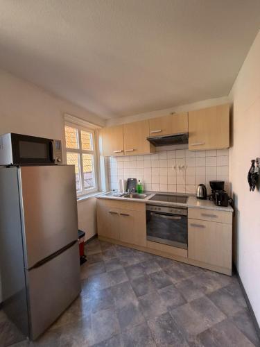 a kitchen with a stainless steel refrigerator and cabinets at Fluss-Bett in Melsungen