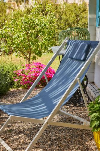 a blue hammock sitting in a yard at Eudaimonia Wooden Suites Nafplio Kandia in Kandia