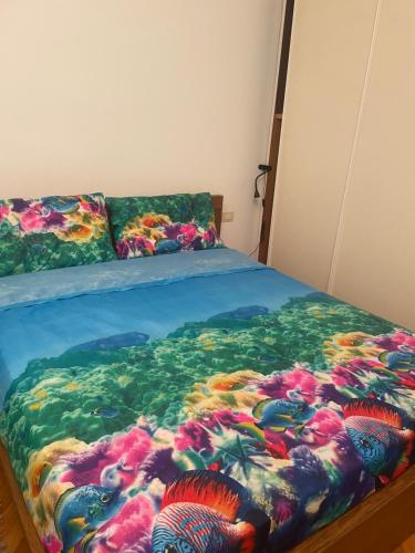 a bed with a painting of fish on it at La casa di Giulia in Genoa
