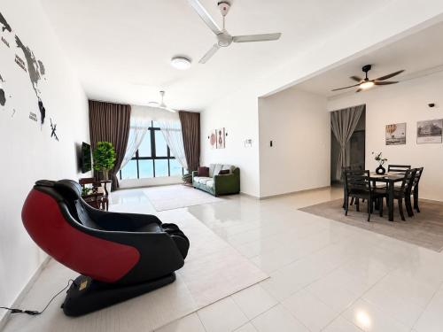 a living room with a red chair on a tile floor at Seabreeze Hideout at Pantai Klebang Netflix I Wifi I Massage Chair I 7 pax in Malacca