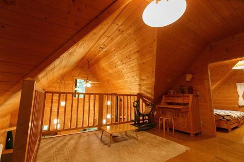 a room with a wooden ceiling with a bed and a desk at ログハウス那須ハイグランド in Nasu