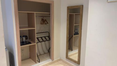 a closet with a mirror in a room at Golden Lotus hotel by Trend in Aqaba