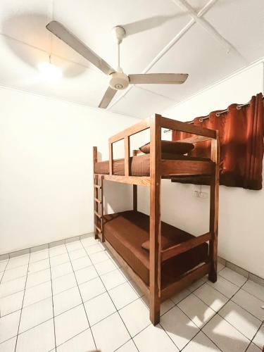 a bunk bed in a room with a ceiling fan at Feel Like Home Hostel Anuradhapura in Anuradhapura