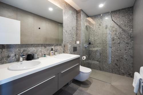 a bathroom with a sink and a shower at Villa LUX 55 in Tučepi