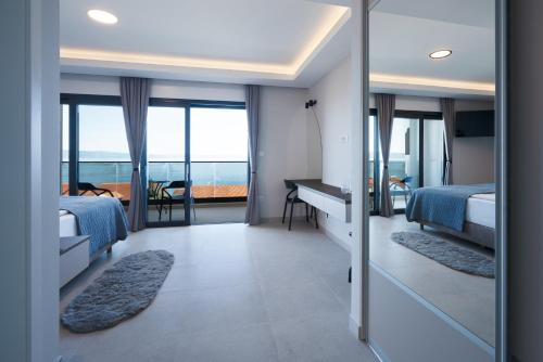 a bedroom with two beds and a view of the ocean at Villa LUX 55 in Tučepi
