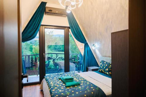 a bedroom with a bed and a large window at A Frame Poalele Transalpinei in Novaci-Străini