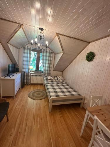 a room with a bed in a attic at Willa Rosiczka in Okuninka