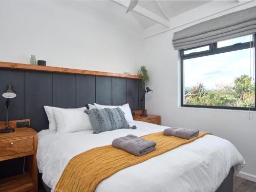 a bedroom with a large bed with two pillows on it at Kiekiebos in Wilderness