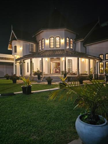 a large white house at night with a plant at Airport Luxury Villa 65 - Negombo-Airport Transit Guest in Negombo
